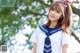 A woman in a sailor outfit posing for a picture.