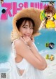 A woman in a straw hat on the cover of a magazine.