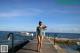 A woman in a bathing suit standing on a dock.